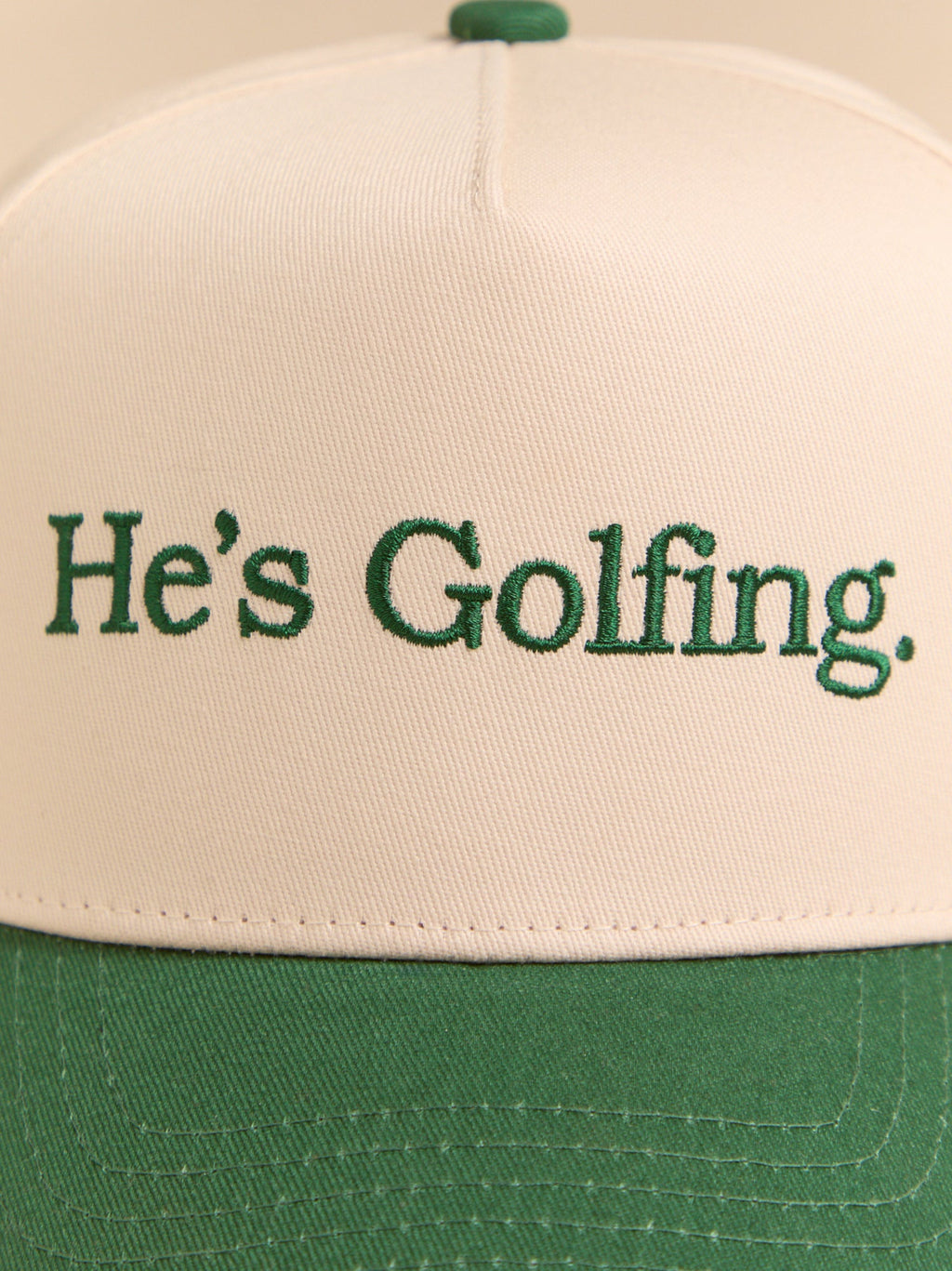 He's Golfing Trucker Hat